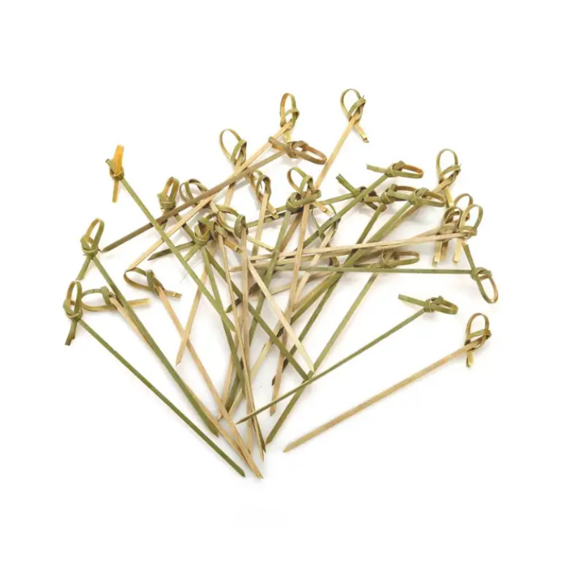 Collection of wooden skewers with green ends on a white background